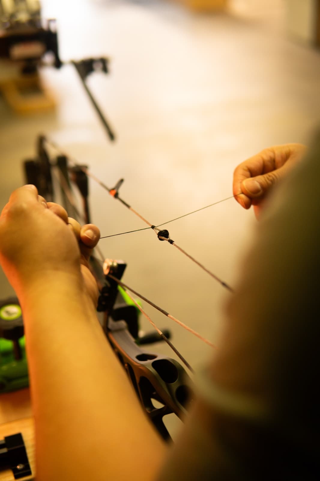 Tying a D-loop onto a bow string on the bench